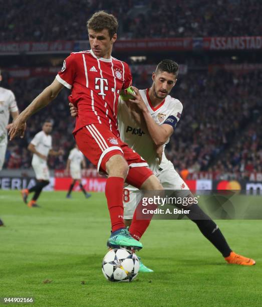 Thomas Mueller of FC Bayern Muenchen fights for the ball with Sergio Escudero of Sevilla FC during the Champions League quarter final second leg...