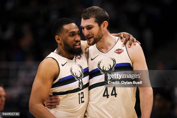 Jabari Parker and Tyler Zeller of the Milwaukee Bucks meet in the fourth quarter against the Orlando Magic at the Bradley Center on April 9, 2018 in...