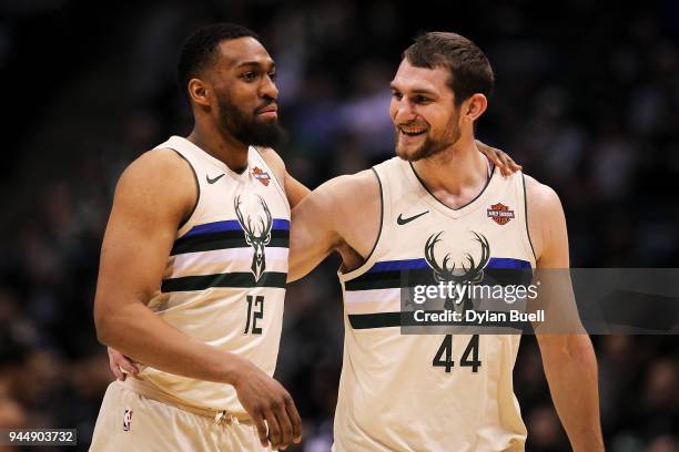 Jabari Parker and Tyler Zeller of the Milwaukee Bucks meet in the fourth quarter against the Orlando Magic at the Bradley Center on April 9, 2018 in...