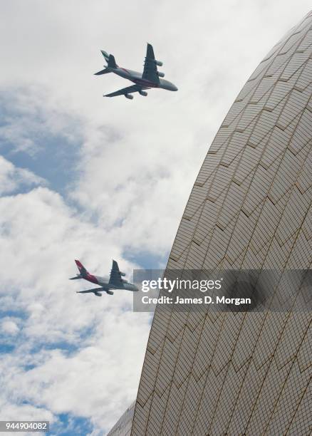 Two Airbus A380's belonging to Qantas and Emirates fly over the top of the Opera House on March 31, 2013 in Sydney, Australia. A Qantas A380 and an...