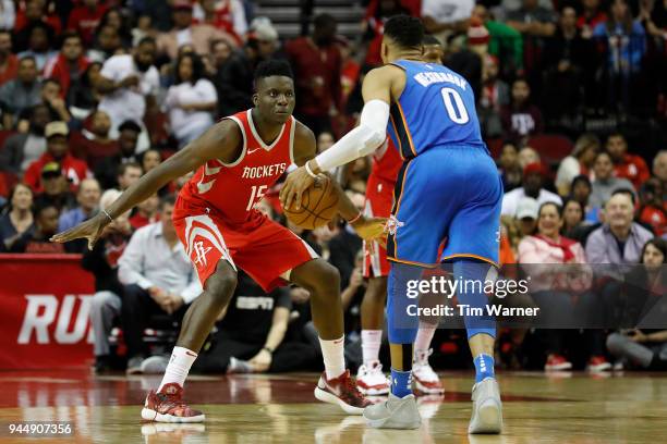 Clint Capela of the Houston Rockets defends Russell Westbrook of the Oklahoma City Thunder in the first half at Toyota Center on April 7, 2018 in...