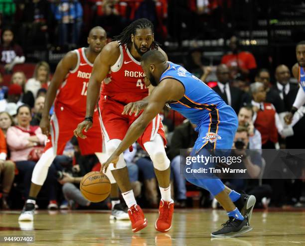 Nene Hilario of the Houston Rockets defends Raymond Felton of the Oklahoma City Thunder in the first half at Toyota Center on April 7, 2018 in...