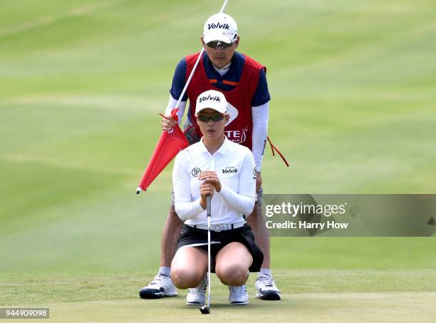 Chella Choi and her father caddie Ji Yeon Choi of South Korea line up a putt on the 10th green during the first round of the LPGA LOTTE Championship...