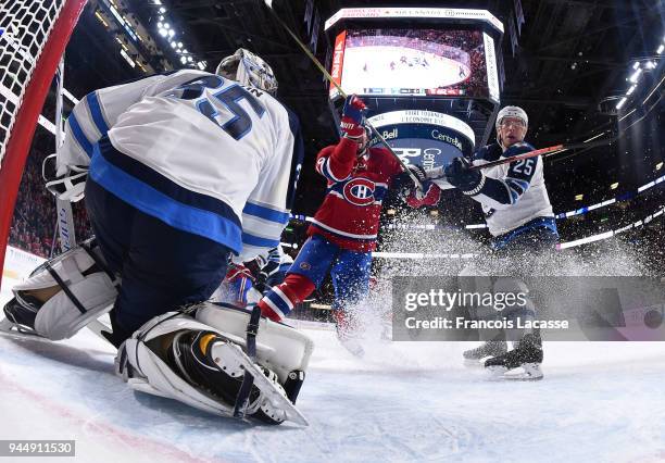 Steve Mason of the Winnipeg Jets defends the goal against the Montreal Canadiens in the NHL game at the Bell Centre on April 3, 2018 in Montreal,...