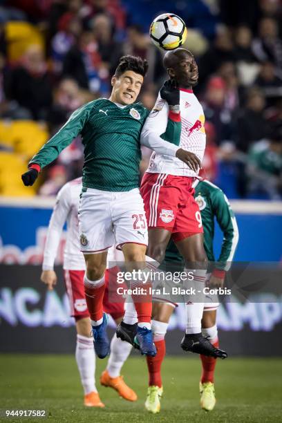 Bradley Wright-Phillips of New York Red Bulls goes up for the header against Michael Perez of Guadalajara during the CONCACAF Champions League -...