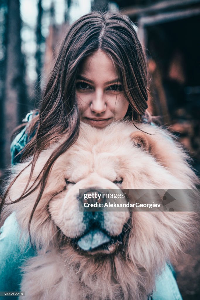 Young Female Hugging her Chow Chow Dog on a Mountain Picnic