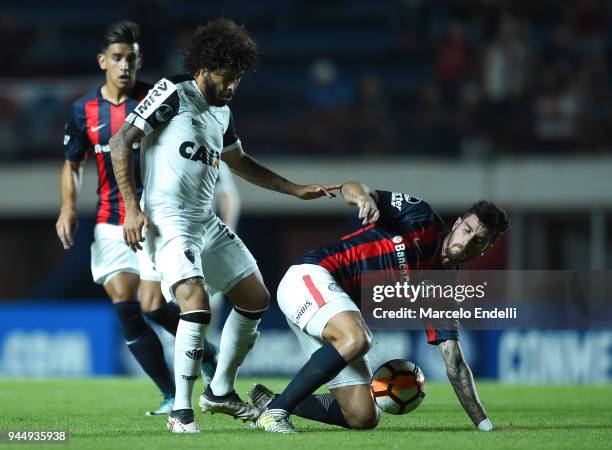 Adilson of Atletico Mineiro fights for ball with Marcos Senesi of San Lorenzo during a match between San Lorenzo and Atletico Mineiro as part of Copa...