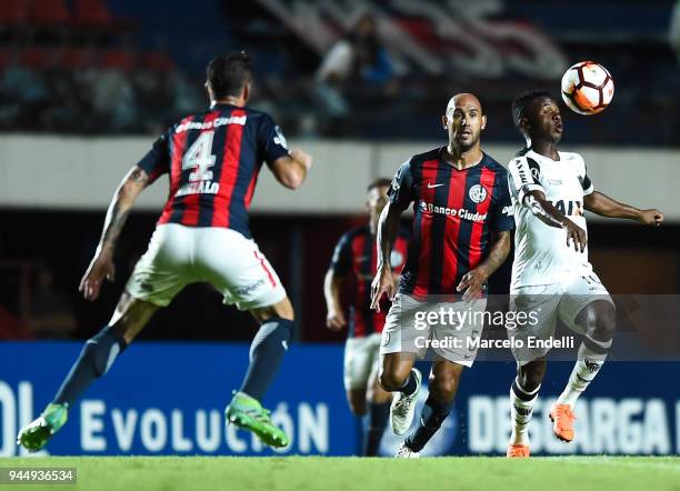 Juan Cazares of Atletico Mineiro fights for the ball with Juan Mercier of San Lorenzo during a match between San Lorenzo and Atletico Mineiro as part...