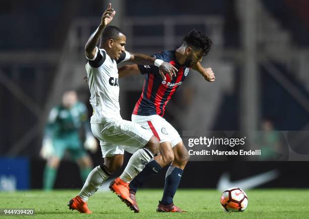 Gabriel Gudino of San Lorenzo fights for the ball with Romulo Otero of Atletico Mineiro during a match between San Lorenzo and Atletico Mineiro as...