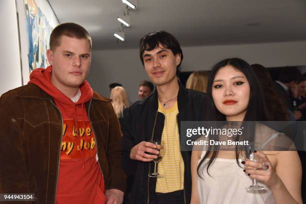 Joe Sweeney, guest and Faye Wei Wei attend a private view of "There" by Tomo Campbell at The Cob Gallery on April 11, 2018 in London, England.
