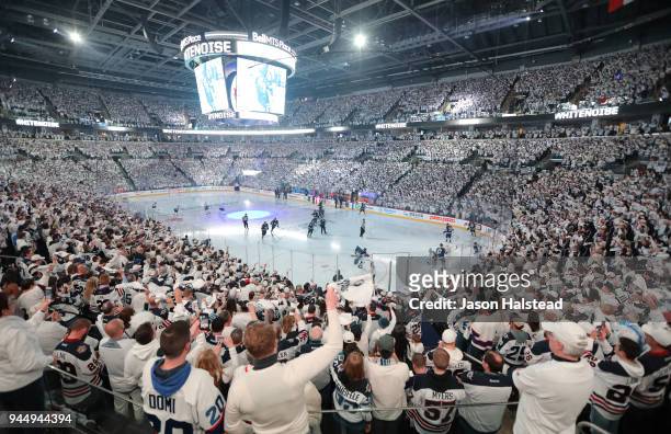 Fans of the Winnipeg Jets welcome their team to the ice as they took on the Minnesota Wild in Game One of the Western Conference First Round during...