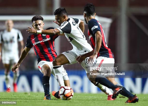 Erik Lima of Atletico Mineiro fights for the ball with Gabriel Rojas of San Lorenzo during a match between San Lorenzo and Atletico Mineiro as part...