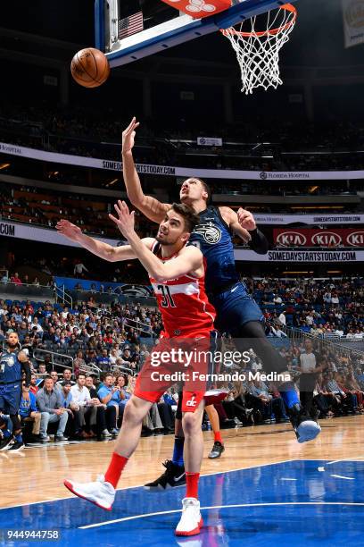 Aaron Gordon of the Orlando Magic reaches for the rebound against Tomas Satoransky of the Washington Wizards on April 11 2018 at Amway Center in...