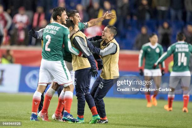 Carlos Salcido of C.D. Guadalajara and Oswaldo Alanis of C.D. Guadalajara celebrate with team mates after the final whistle during the New York Red...