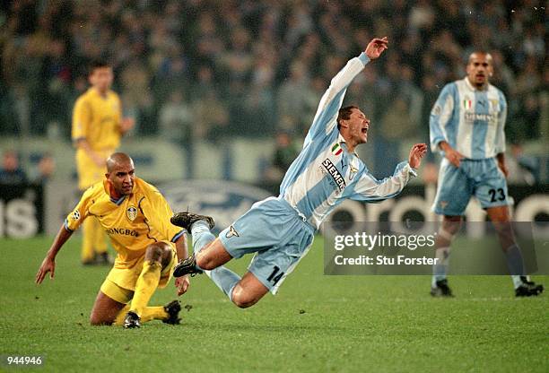 Diego Simeone of Lazio is felled by Olivier Dacourt of Leeds United during the UEFA Champions League match at the Stadio Olympico in Rome, Italy....