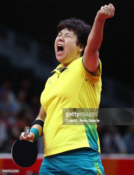 Jian Fang Lay of Australia celebrates a point in her women's doubles match with team mate Miao Miao, against Ye Lin and Yihan Zhou of Singapore...