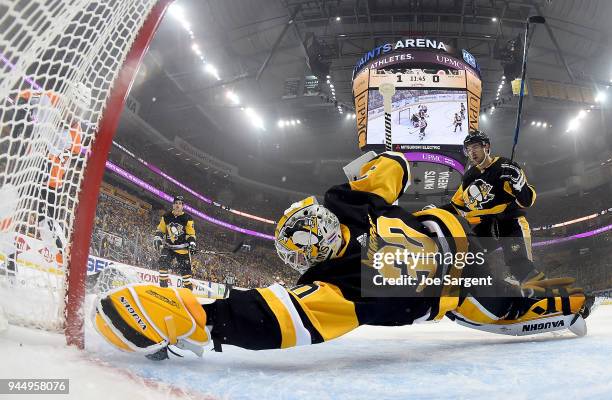 Matt Murray of the Pittsburgh Penguins makes a diving save against Scott Laughton of the Philadelphia Flyers in Game One of the Eastern Conference...