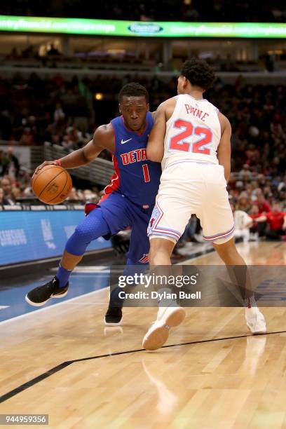 Reggie Jackson of the Detroit Pistons dribbles the ball while being guarded by Cameron Payne of the Chicago Bulls in the first quarter at the United...