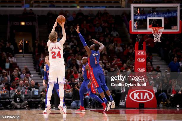 Lauri Markkanen of the Chicago Bulls attempts a shot while being guarded by Reggie Jackson of the Detroit Pistons in the first quarter at the United...