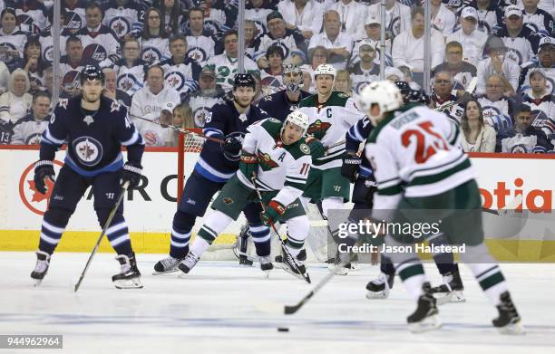 Jonas Brodin of the Minnesota Wild looks to shoot against the Winnipeg Jets as Joel Armia, Jacob Trouba, Connor Hellebuyck, Josh Morrissey of the...