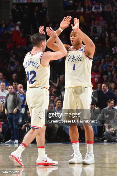 McConnell and Justin Anderson of the Philadelphia 76ers exchange a high five during the game against the Milwaukee Bucks on April 11, 2018 in...