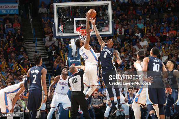 Paul George of the Oklahoma City Thunder and MarShon Brooks of the Memphis Grizzlies reach for the tip-off during the game on April 11, 2018 at...
