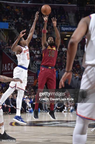 John Holland of the Cleveland Cavaliers shoots the ball against Frank Ntilikina of the New York Knicks on April 11, 2018 at Quicken Loans Arena in...