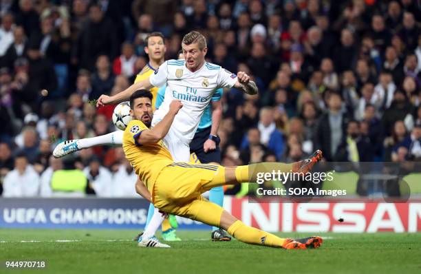 Kroos competes for the ball with Sami Khedira during the UEFA Champions league round of quarter final match second leg football match between Real...