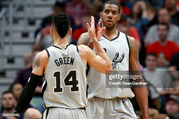 Danny Green of the San Antonio Spurs and LaMarcus Aldridge of the San Antonio Spurs react after scoring during the first half of a NBA game against...