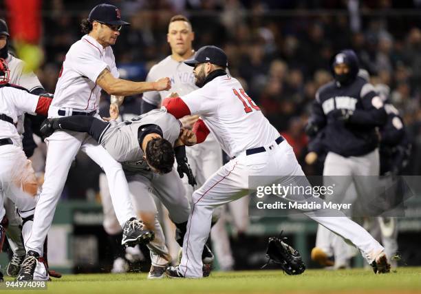 Mitch Moreland of the Boston Red Sox, right, works to separate Joe Kelly and Tyler Austin of the New York Yankees during the seventh inning at Fenway...