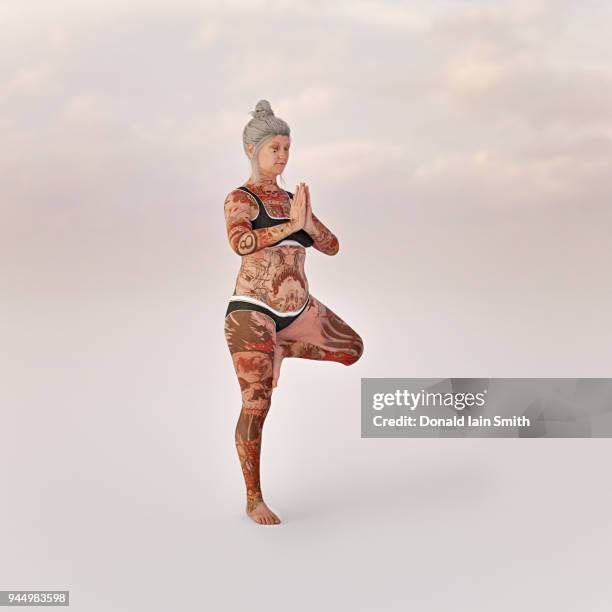 older lady with tattoos doing yoga - old woman tattoos stock pictures, royalty-free photos & images