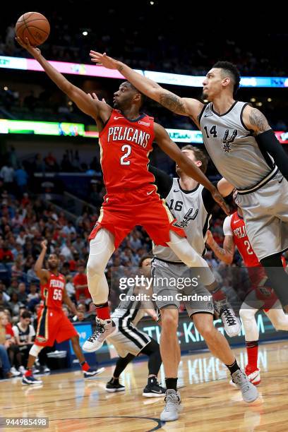 Ian Clark of the New Orleans Pelicans shoots over Danny Green of the San Antonio Spurs during the second half of a NBA game at the Smoothie King...