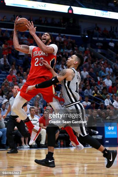 Anthony Davis of the New Orleans Pelicans is fouled by Danny Green of the San Antonio Spurs during the second half of a NBA game at the Smoothie King...