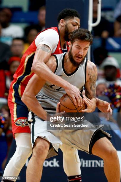 Joffrey Lauvergne of the San Antonio Spurs is fouled by Anthony Davis of the New Orleans Pelicans during the second half of a NBA game at the...