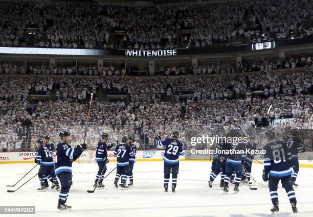 Winnipeg Jets players salutes the fans as they leave the ice following a 3-2 victory over the Minnesota Wild in Game One of the Western Conference...