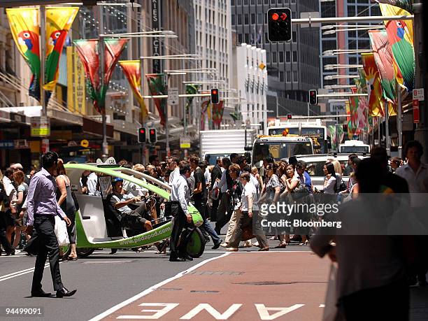 Pedestrians cross the street in the central business district of Sydney, Australia, on Wednesday, Dec. 16, 2009. Australia's economy expanded in the...
