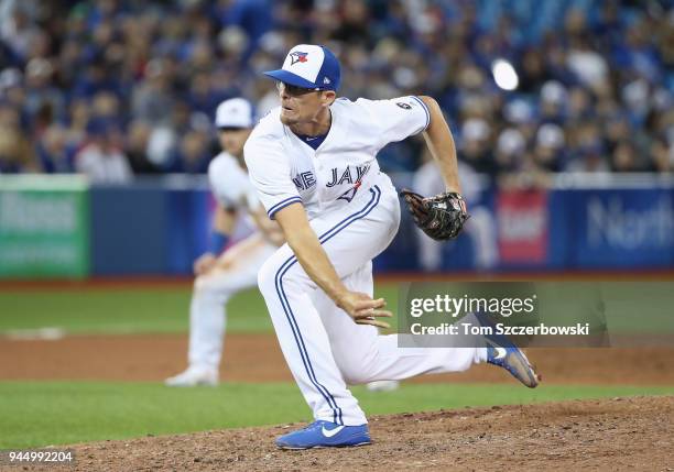 Tyler Clippard of the Toronto Blue Jays delivers a pitch in the ninth inning on Opening Day during MLB game action against the New York Yankees at...