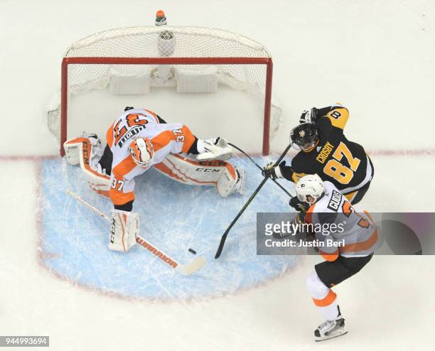 Brian Elliott of the Philadelphia Flyers makes a save on a shot attempt by Sidney Crosby of the Pittsburgh Penguins during the first period in Game...