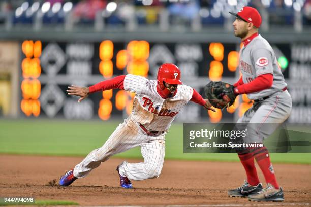 Philadelphia Phillies right fielder Nick Williams dives back to first during the MLB game between the Cincinnati Reds and the Philadelphia Phillies...