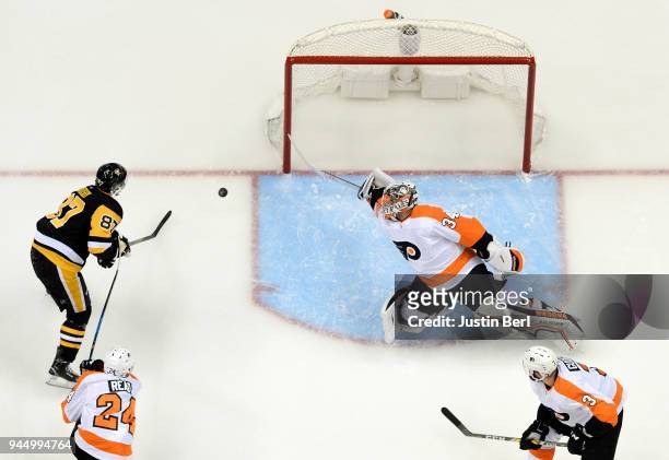 Sidney Crosby of the Pittsburgh Penguins scores a goal past Petr Mrazek of the Philadelphia Flyers during the third period in Game One of the Eastern...