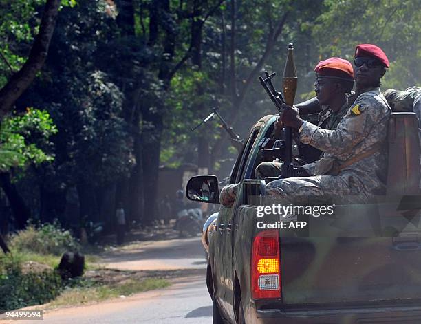 Military car of Guinea's interim head of state General Sekouba Konate escorts him to Kindia military camp, some 130 kms from Conakry on December 16,...