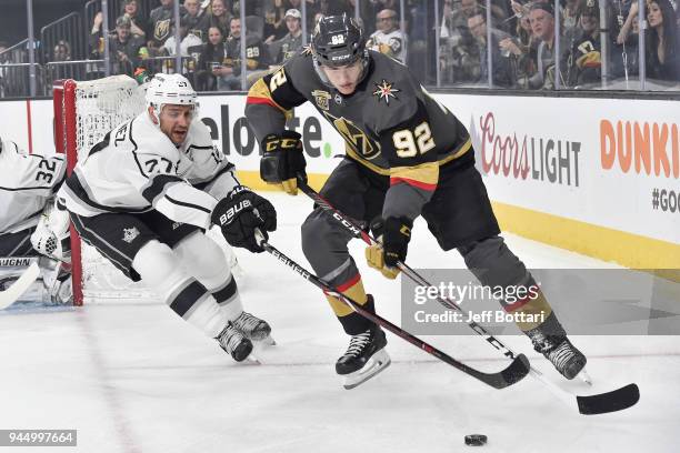 Tomas Nosek of the Vegas Golden Knights skates with the puck while Alec Martinez of the Los Angeles Kings defends in Game One of the Western...