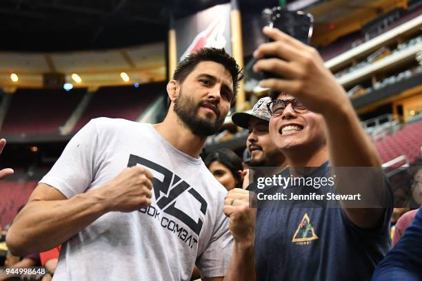 Carlos Condit takes a photo with a fan during an open workout at Gila River Arena on April 11, 2018 in Glendale, Arizona.