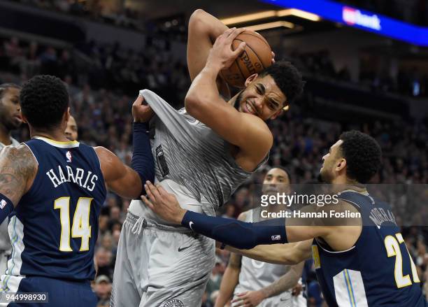 Karl-Anthony Towns of the Minnesota Timberwolves rebounds the ball against Gary Harris and Jamal Murray of the Denver Nuggets during the fourth...