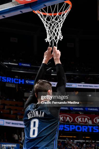 Mario Hezonja of the Orlando Magic hangs on to the net during the game against the Washington Wizards on April 11 2018 at Amway Center in Orlando,...