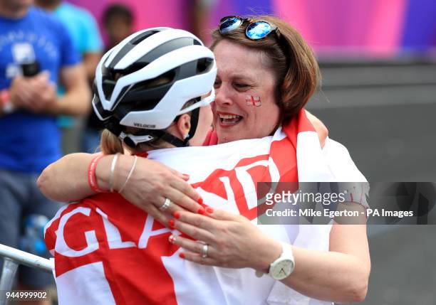 England's Evie Richards celebrates winning silver with relatives in the Women's Cross-Country at the Nerang Mountain Bike Trails during day eight of...