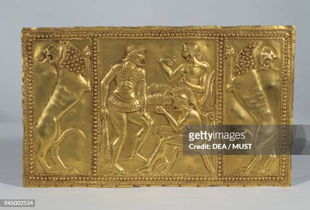 Embossed gold plaque with mythological figures.