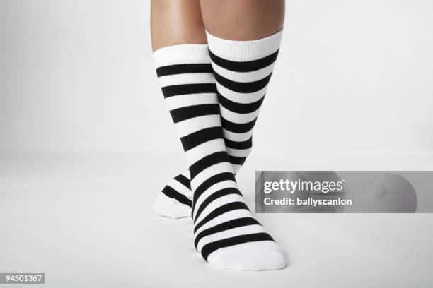 woman wearing striped socks. - white women feet fotografías e imágenes de stock