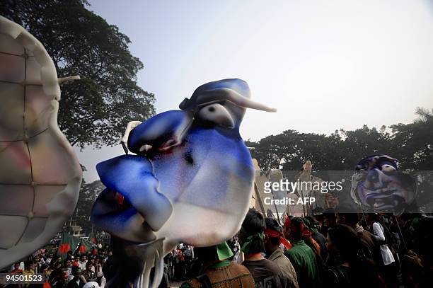 Bangladeshi people hold colourful masks during a rally held to mark the country's 38th Victory Day in Dhaka on December 16, 2009. Bangladesh won...