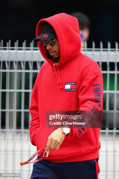 Lewis Hamilton of Great Britain and Mercedes GP walks in the Paddock during previews ahead of the Formula One Grand Prix of China at Shanghai...